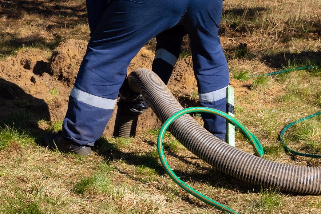 worker doing trash pump